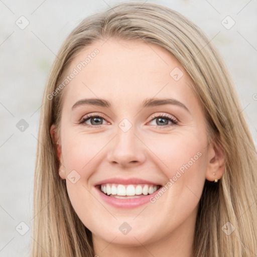 Joyful white young-adult female with long  brown hair and blue eyes