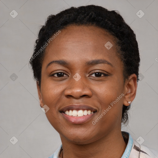 Joyful black young-adult female with short  black hair and brown eyes