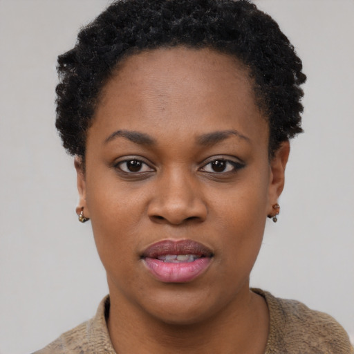 Joyful black young-adult female with short  black hair and brown eyes