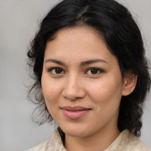 Joyful latino young-adult female with medium  brown hair and brown eyes