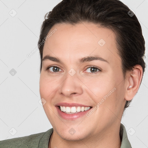 Joyful white young-adult female with short  brown hair and brown eyes