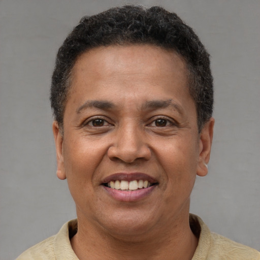 Joyful latino adult female with short  brown hair and brown eyes