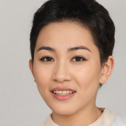 Joyful asian young-adult female with short  brown hair and brown eyes