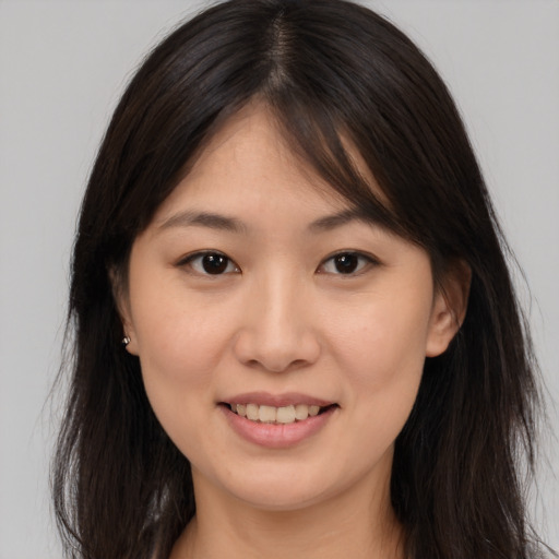 Joyful asian young-adult female with long  brown hair and brown eyes