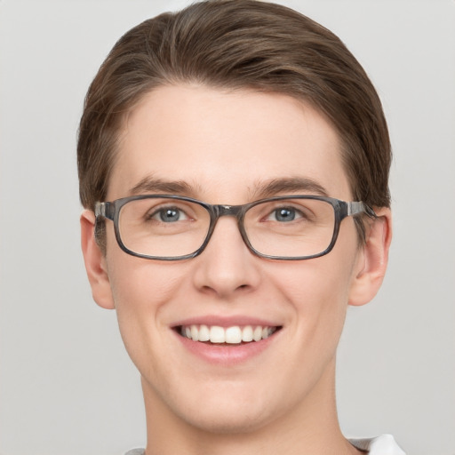 Joyful white young-adult male with short  brown hair and grey eyes