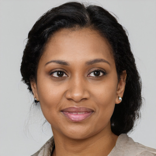 Joyful black young-adult female with medium  brown hair and brown eyes