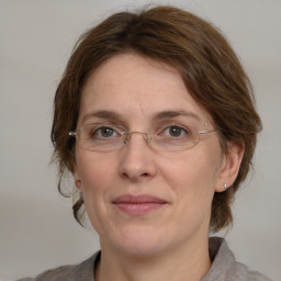 Joyful white adult female with medium  brown hair and grey eyes