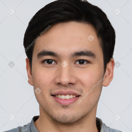 Joyful asian young-adult male with short  brown hair and brown eyes