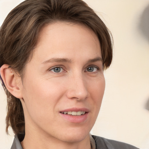 Joyful white young-adult female with medium  brown hair and grey eyes