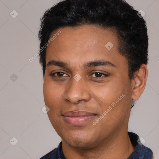 Joyful black young-adult male with short  black hair and brown eyes