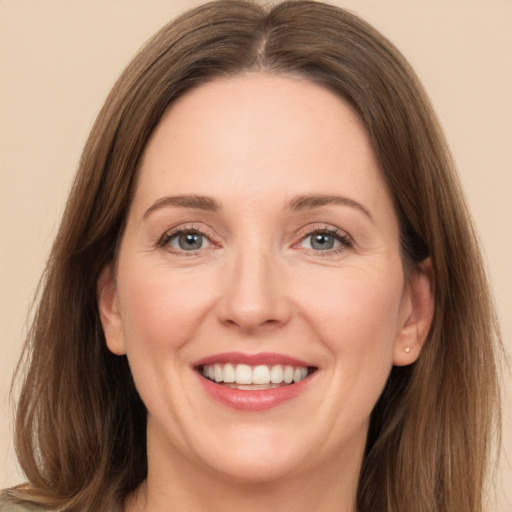 Joyful white adult female with medium  brown hair and grey eyes