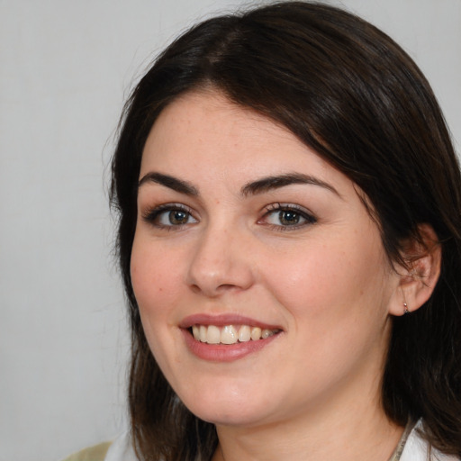 Joyful white young-adult female with medium  brown hair and brown eyes