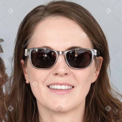 Joyful white young-adult female with long  brown hair and blue eyes