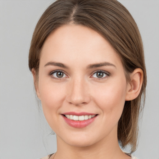 Joyful white young-adult female with medium  brown hair and brown eyes