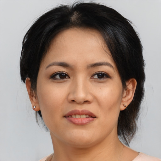 Joyful asian adult female with medium  brown hair and brown eyes