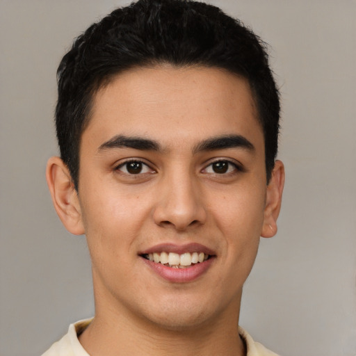 Joyful latino young-adult male with short  brown hair and brown eyes