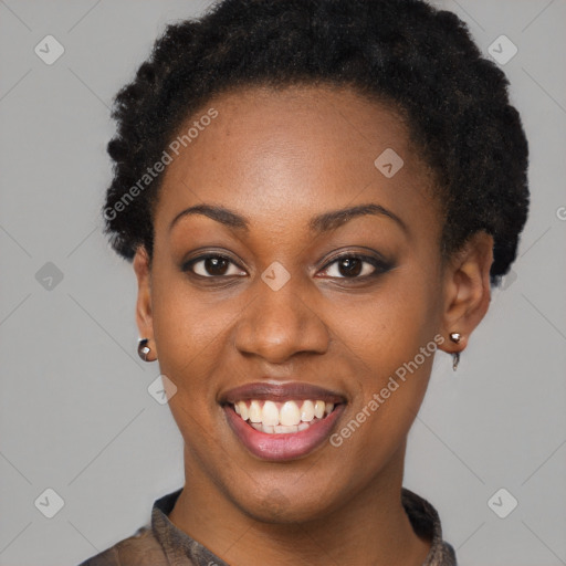 Joyful black young-adult female with short  black hair and brown eyes