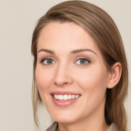 Joyful white young-adult female with long  brown hair and blue eyes