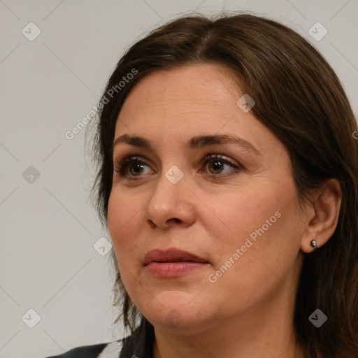 Joyful white adult female with medium  brown hair and brown eyes