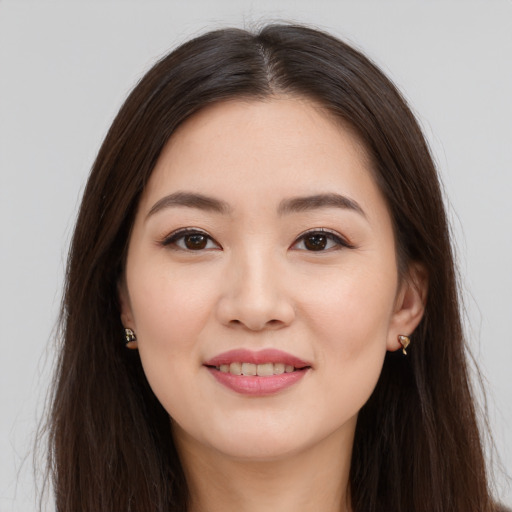 Joyful asian young-adult female with long  brown hair and brown eyes