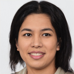 Joyful asian young-adult female with medium  black hair and brown eyes