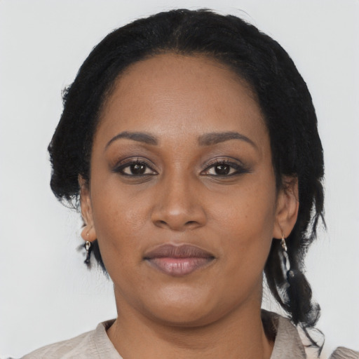 Joyful black adult female with medium  black hair and brown eyes