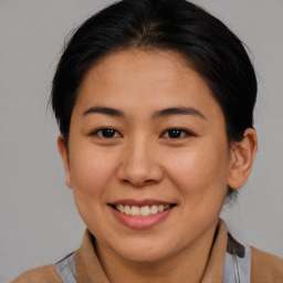 Joyful asian young-adult female with medium  brown hair and brown eyes