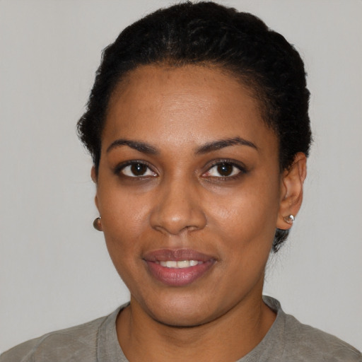 Joyful latino young-adult female with short  black hair and brown eyes
