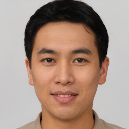 Joyful asian young-adult male with short  black hair and brown eyes