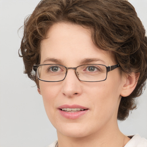 Joyful white adult female with medium  brown hair and green eyes