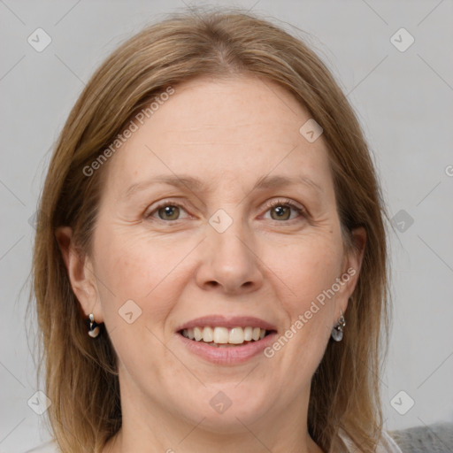 Joyful white adult female with medium  brown hair and grey eyes