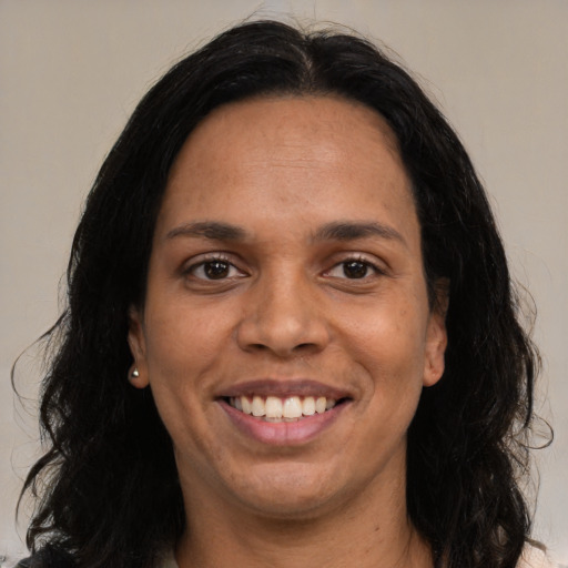 Joyful white adult female with medium  black hair and brown eyes
