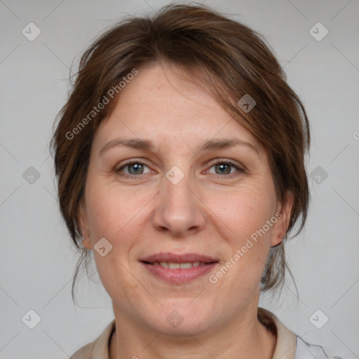 Joyful white adult female with medium  brown hair and grey eyes