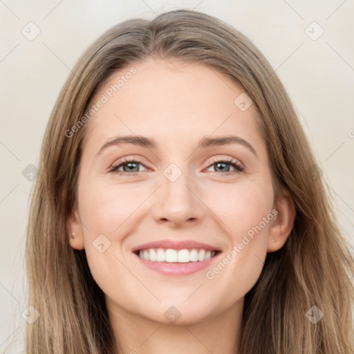 Joyful white young-adult female with long  brown hair and grey eyes