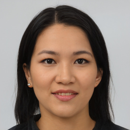 Joyful asian young-adult female with long  black hair and brown eyes