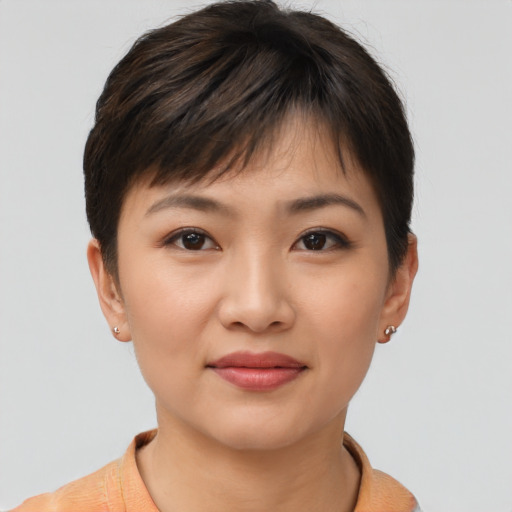 Joyful asian young-adult female with short  brown hair and brown eyes