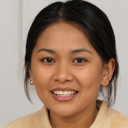 Joyful latino young-adult female with medium  brown hair and brown eyes