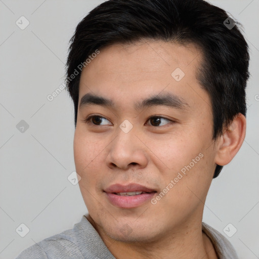 Joyful asian young-adult male with short  black hair and brown eyes