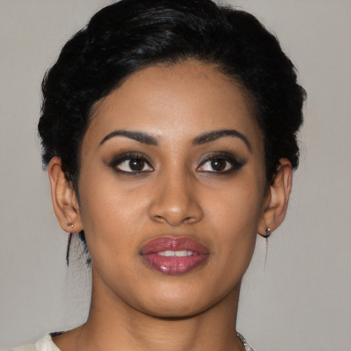 Joyful latino young-adult female with short  black hair and brown eyes
