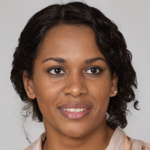Joyful black young-adult female with medium  brown hair and brown eyes