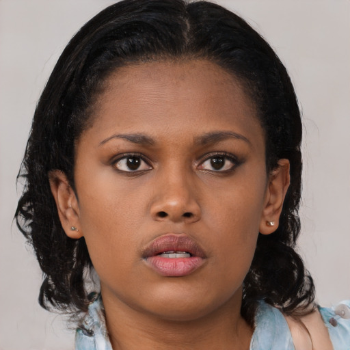Neutral black young-adult female with medium  brown hair and brown eyes
