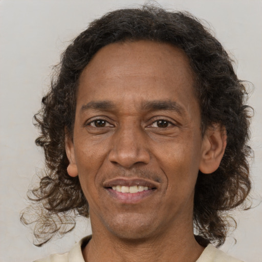 Joyful latino adult male with medium  brown hair and brown eyes