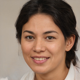 Joyful latino adult female with medium  brown hair and brown eyes