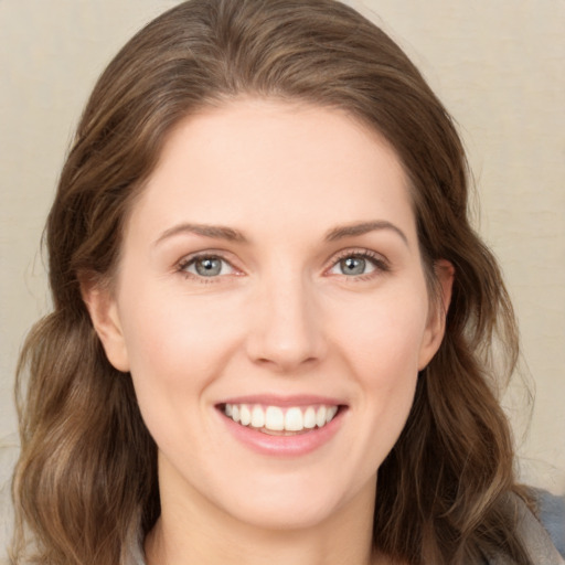 Joyful white young-adult female with medium  brown hair and green eyes