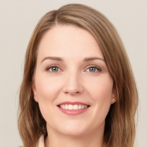 Joyful white young-adult female with long  brown hair and blue eyes