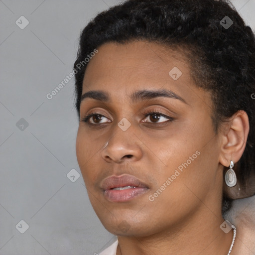 Joyful black young-adult female with short  black hair and brown eyes