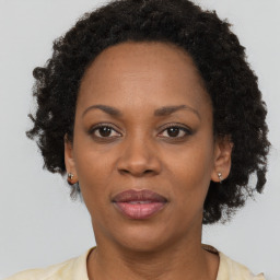 Joyful black adult female with short  brown hair and brown eyes