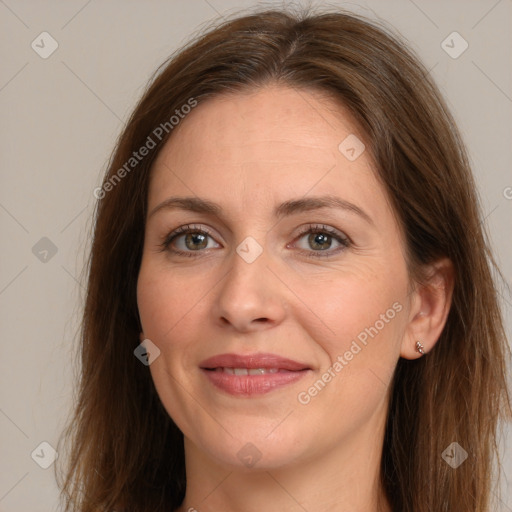 Joyful white adult female with long  brown hair and grey eyes