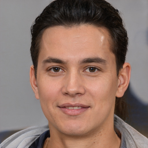 Joyful white young-adult male with short  brown hair and brown eyes