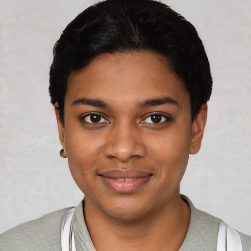 Joyful black young-adult female with short  black hair and brown eyes